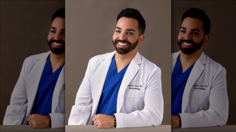 Dr. Muneeb Shab posing in white coat and smiling