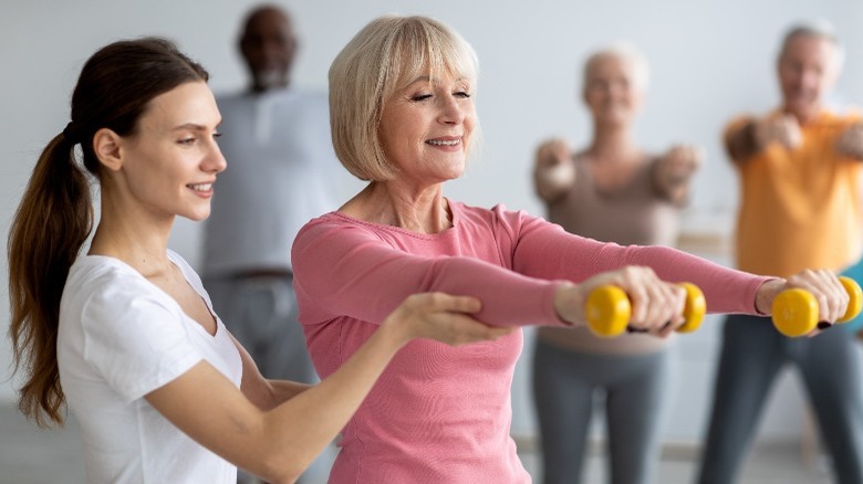 Older woman exercising with dumbbells