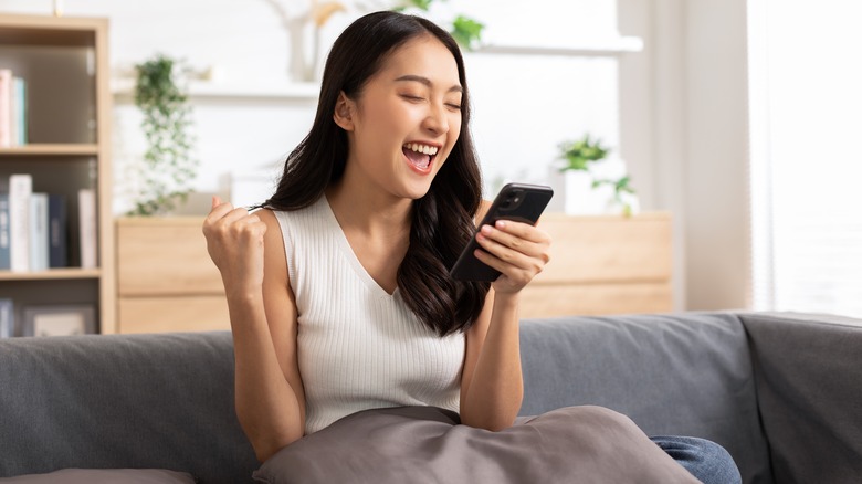 Excited woman holding phone