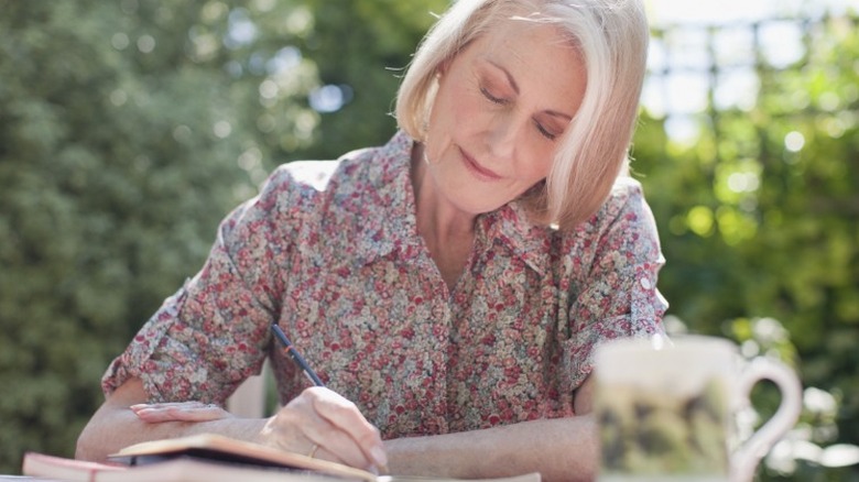 Older woman writing in journal