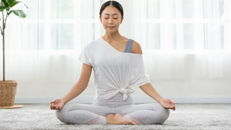 woman practicing yoga at home 