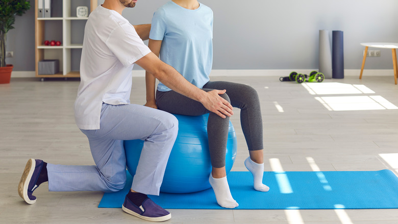 Woman on exercise ball for physical therapy