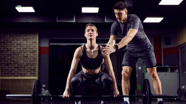 woman getting help from trainer