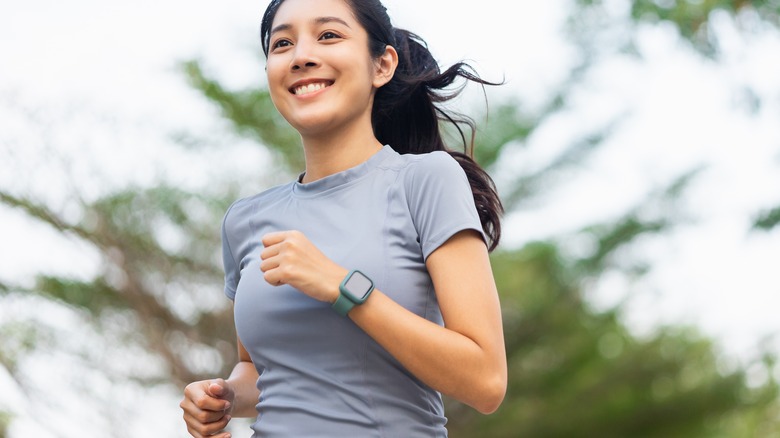 Woman jogging in grey outfit