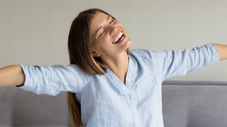 woman sitting up in bed looking refreshed