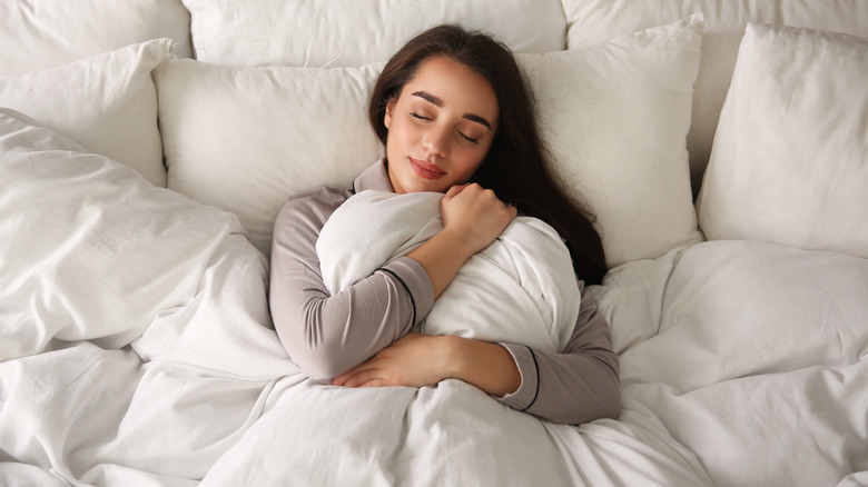 Woman wrapped in a soft blanket sleeping