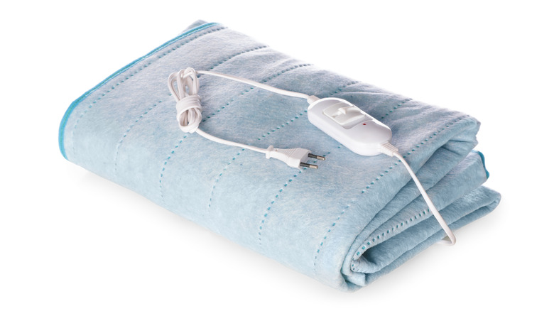 Folded electric heating pad on white background