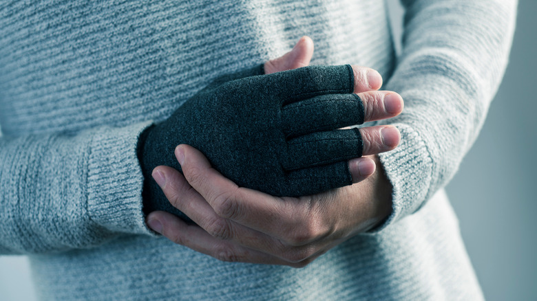 A man wearing a compression glove