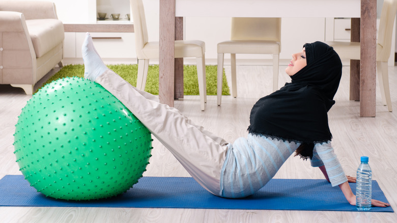 Woman working out with yoga ball