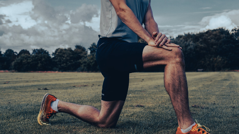 man doing hip flexor stretch