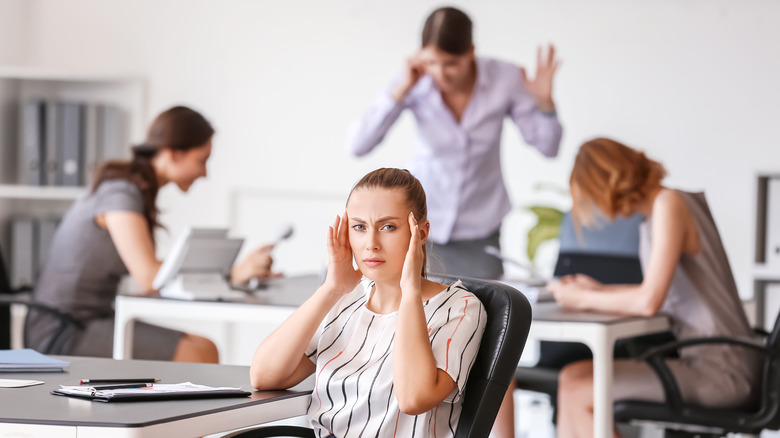 woman headache noisy office