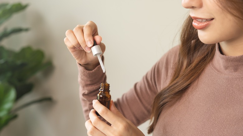 woman applying essential oil