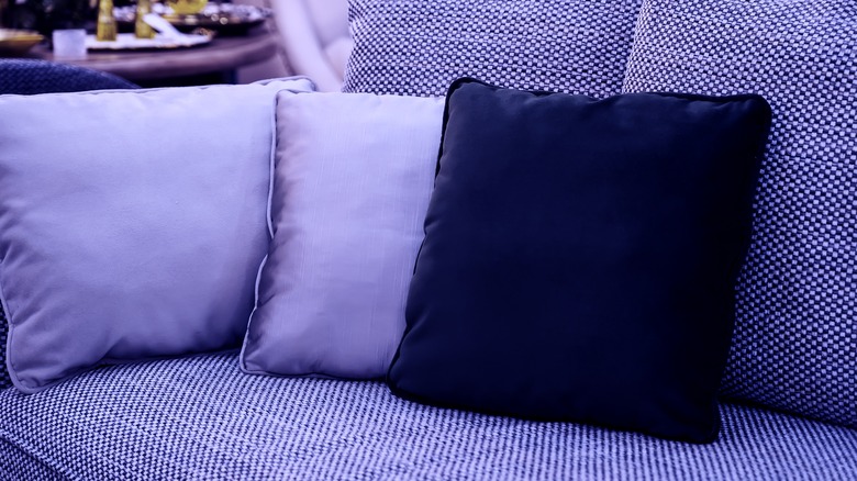 sofa with purple and blue pillows