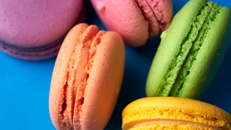 colorful macarons on blue surface