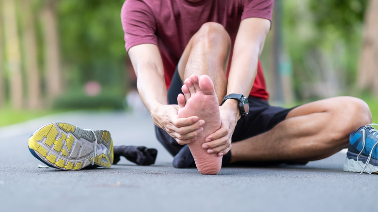 Man holding his foot