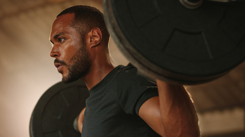 man working out with barbell