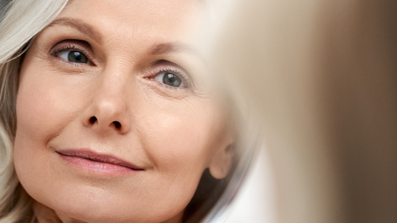 woman looking at self in mirror