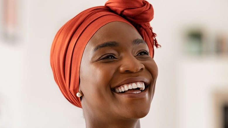 woman with head scarf smiling