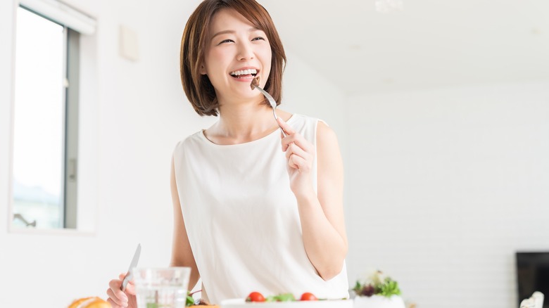 Asian woman eating