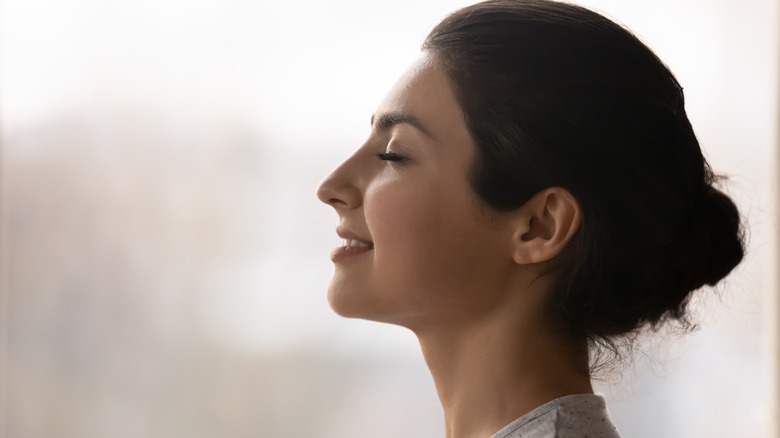 woman performing breathing exercises