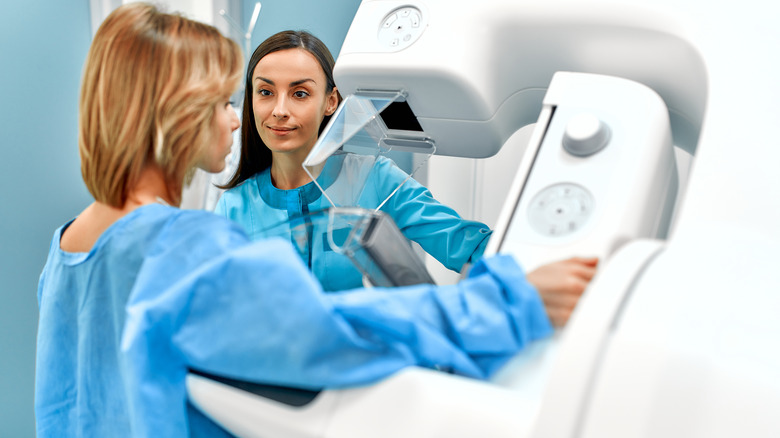 woman having mammogram with technologist