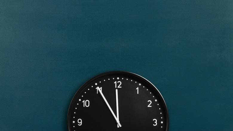 round wall clock on a blue wall