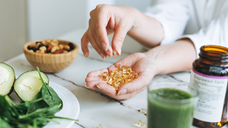 a woman making a healthy meal and adds supplements 