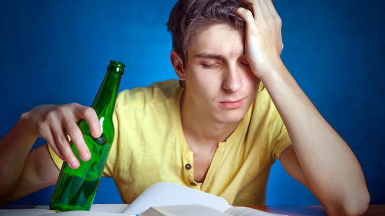tired student drinking beer