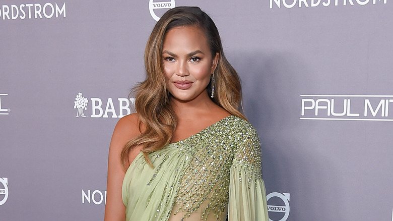 Smiling Chrissy Teigen at a baby event