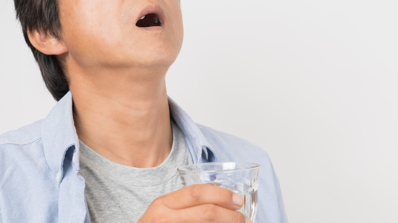 man gargling salt water