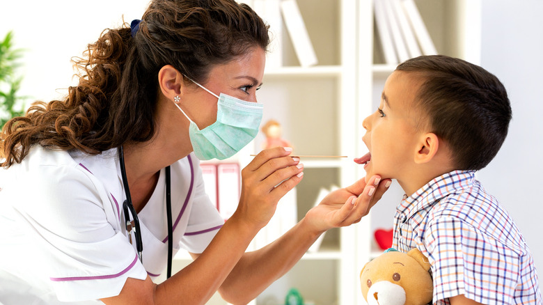 doctor examining young patient