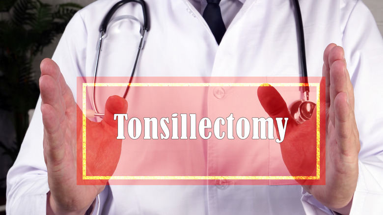 doctor holding tonsillectomy sign