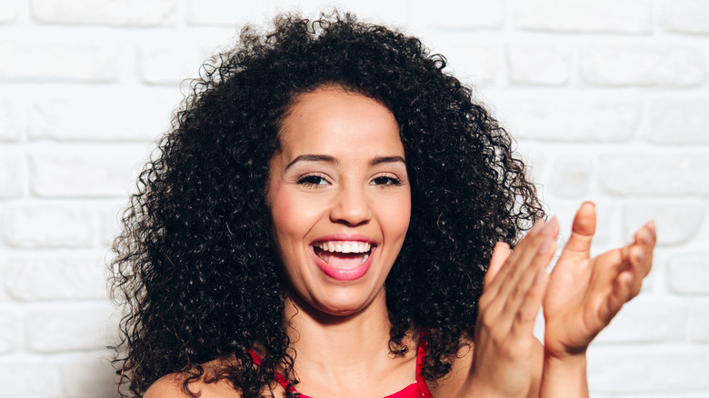 woman smiling and clapping