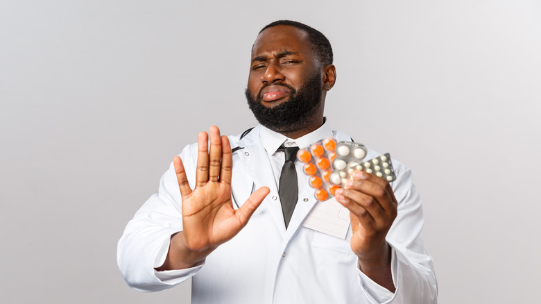 Doctor signaling to avoid pills