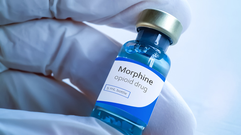 doctor holding Morphine in glass vial