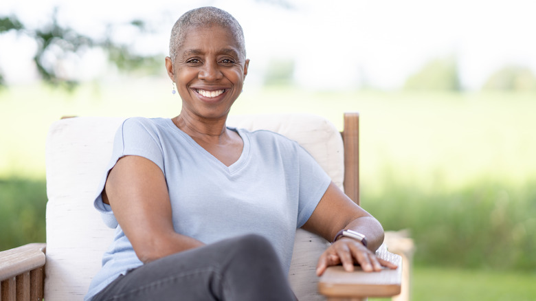 Smiling woman sitting on porch