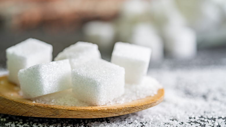 sugar cubes on wooden spoon