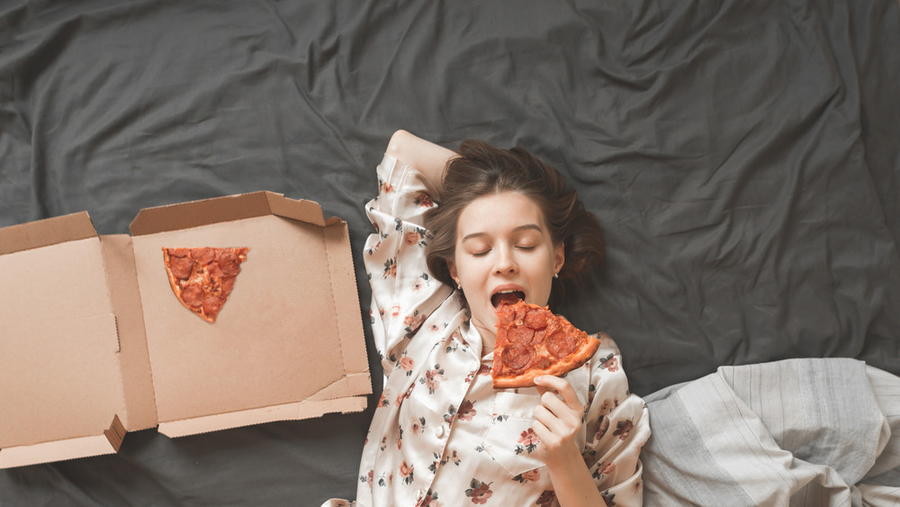 woman eating in bed