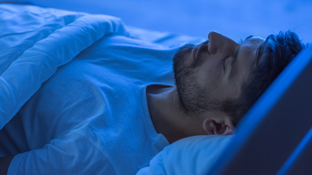 man sleeping with blanket