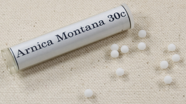 Arnica pills on cloth surface