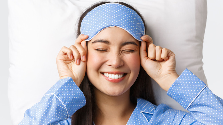 A woman wearing a sleep mask