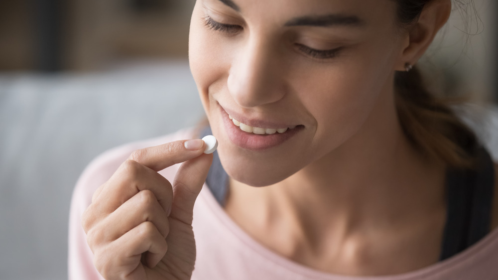 woman taking vitamin