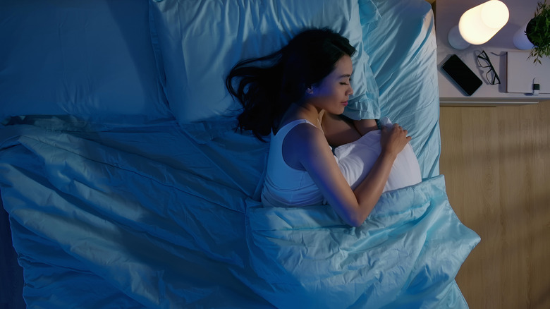 Woman restfully sleeping in bed