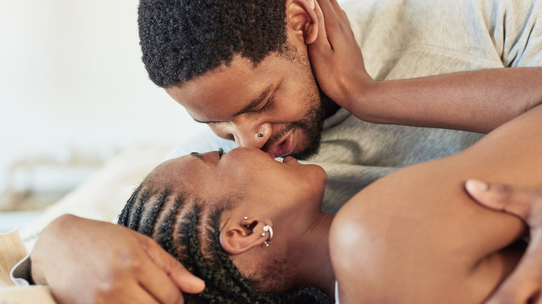 Couple kissing in bed