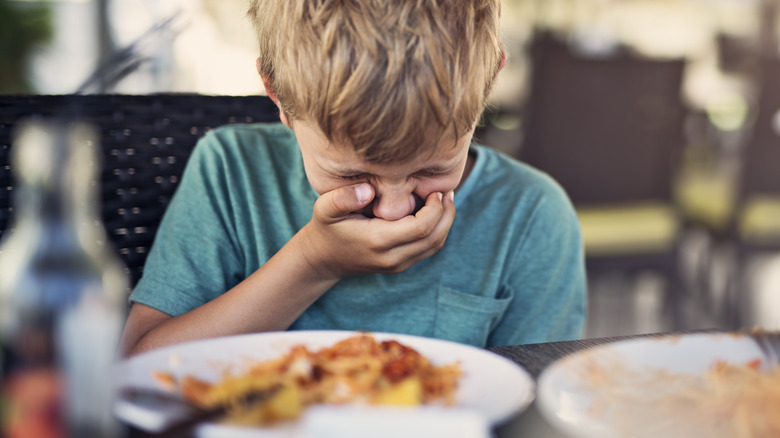 boy sick eating pasta