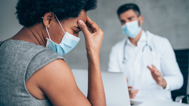 woman talking to doctor about migraine