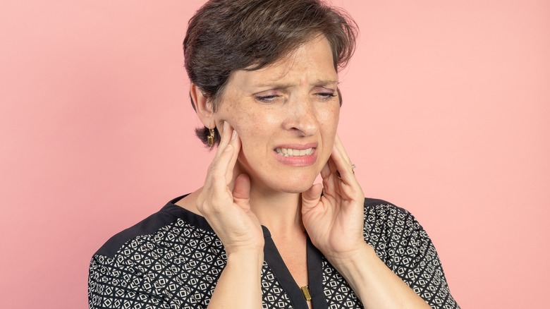 Woman touching her jaw