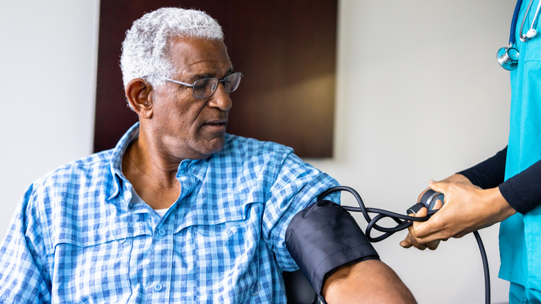 older male getting his blood pressure checked