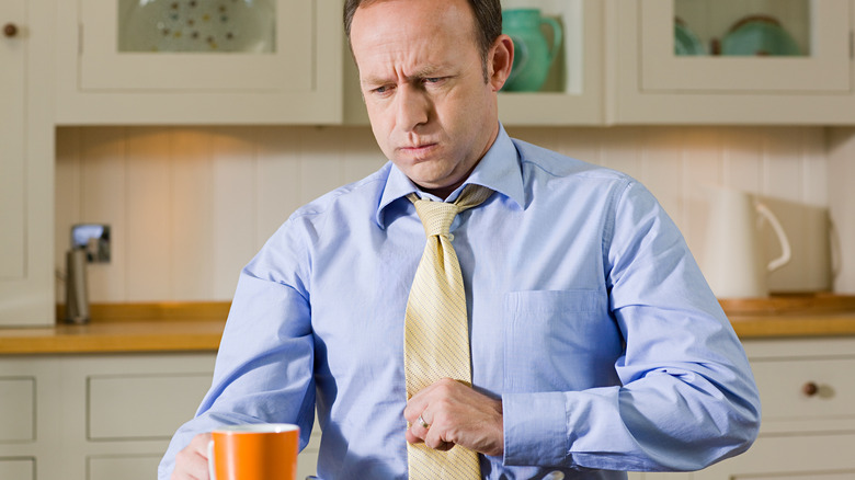 man with indigestion holding his stomach