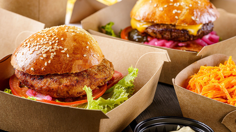 fast food burgers in takeout containers